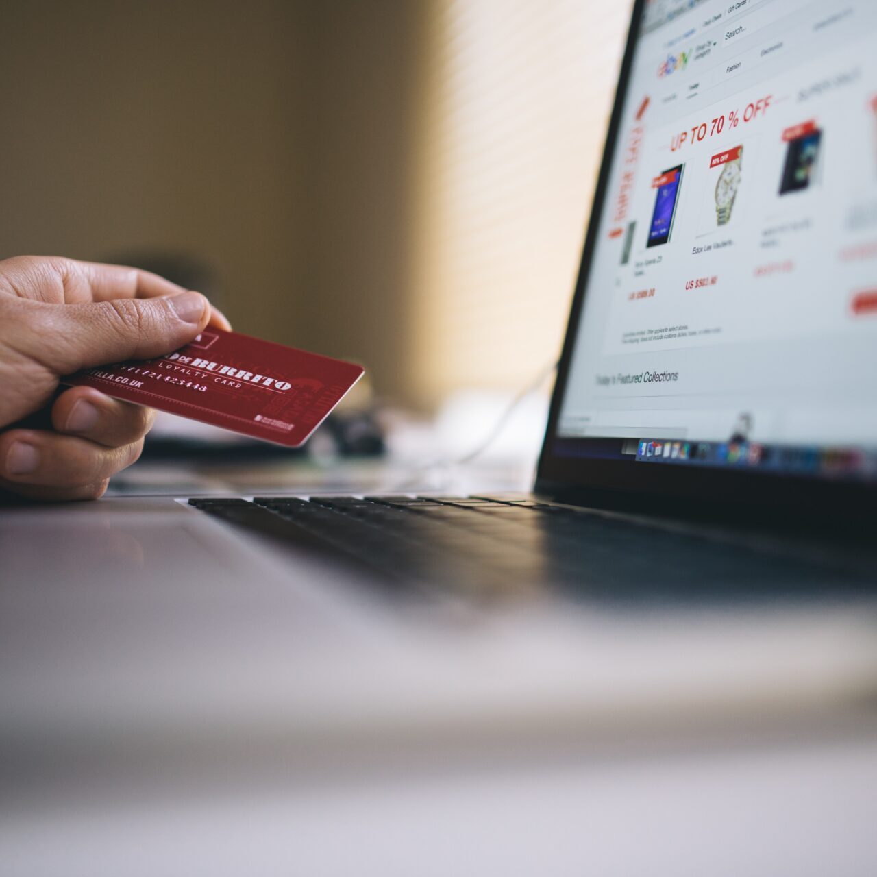 A person using a debit card for an online purchase