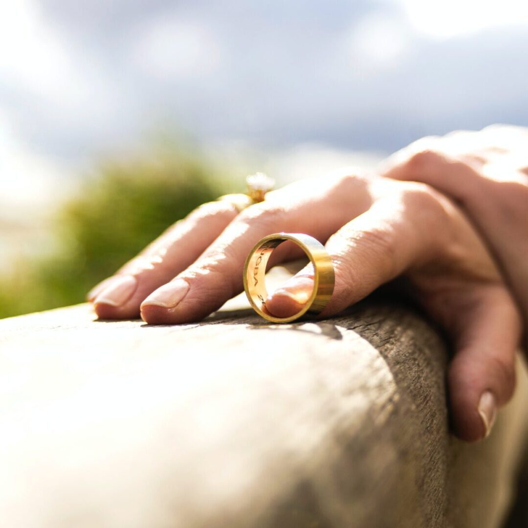 A person wearing a golden ring