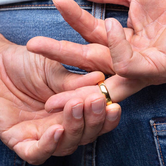 A man removing his wedding ring