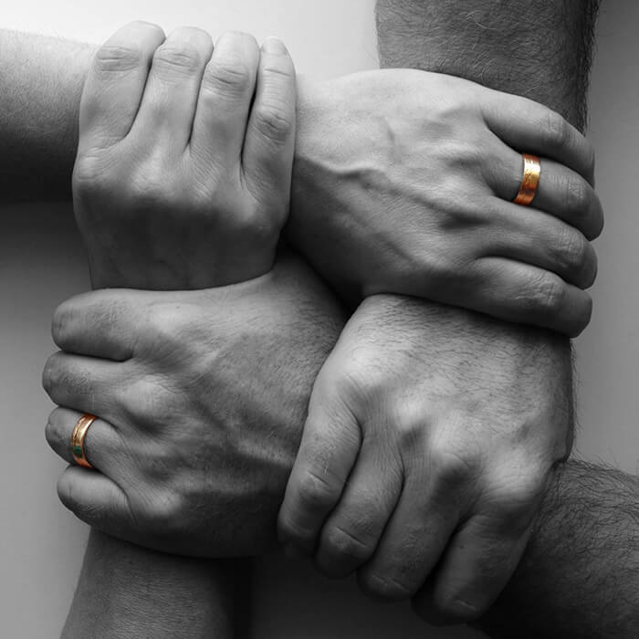 Four people holding each other’s wrists